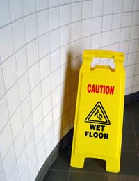 A wet floor sign warning of risk of accident at work