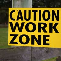 Sign saying "caution work zone" - one example of managing risks in the workplace