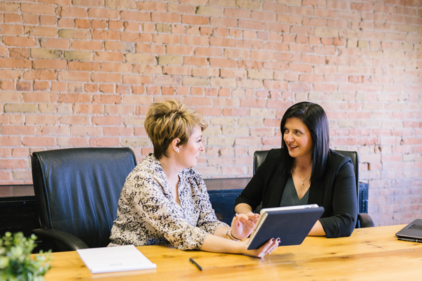 manager and employee discussing probation period at a desk in an office