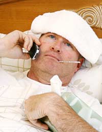 sick worker in bed phoning his workplace