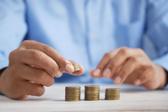 Self employed sick pay - coins being counted on a table.